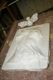 A photo of a plaster sculpture at an incomplete phase